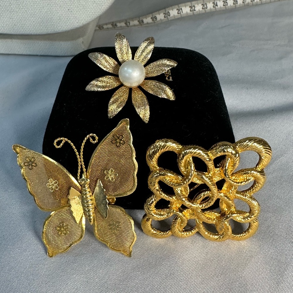 Group of three goldtone brooch pins